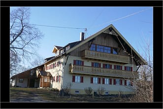 Heute ist die Front der Hirschau 2 mit gelben Balkonen ausgestattet, die Fassade in gelb gestrichen. Den Giebel ziert eine hölzerne Sonne. © Tanja Saß Hirschau im Frühling